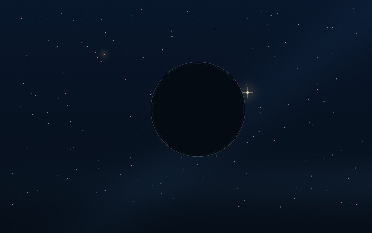 A small dark disc beside a bright star in a deep blue star field
