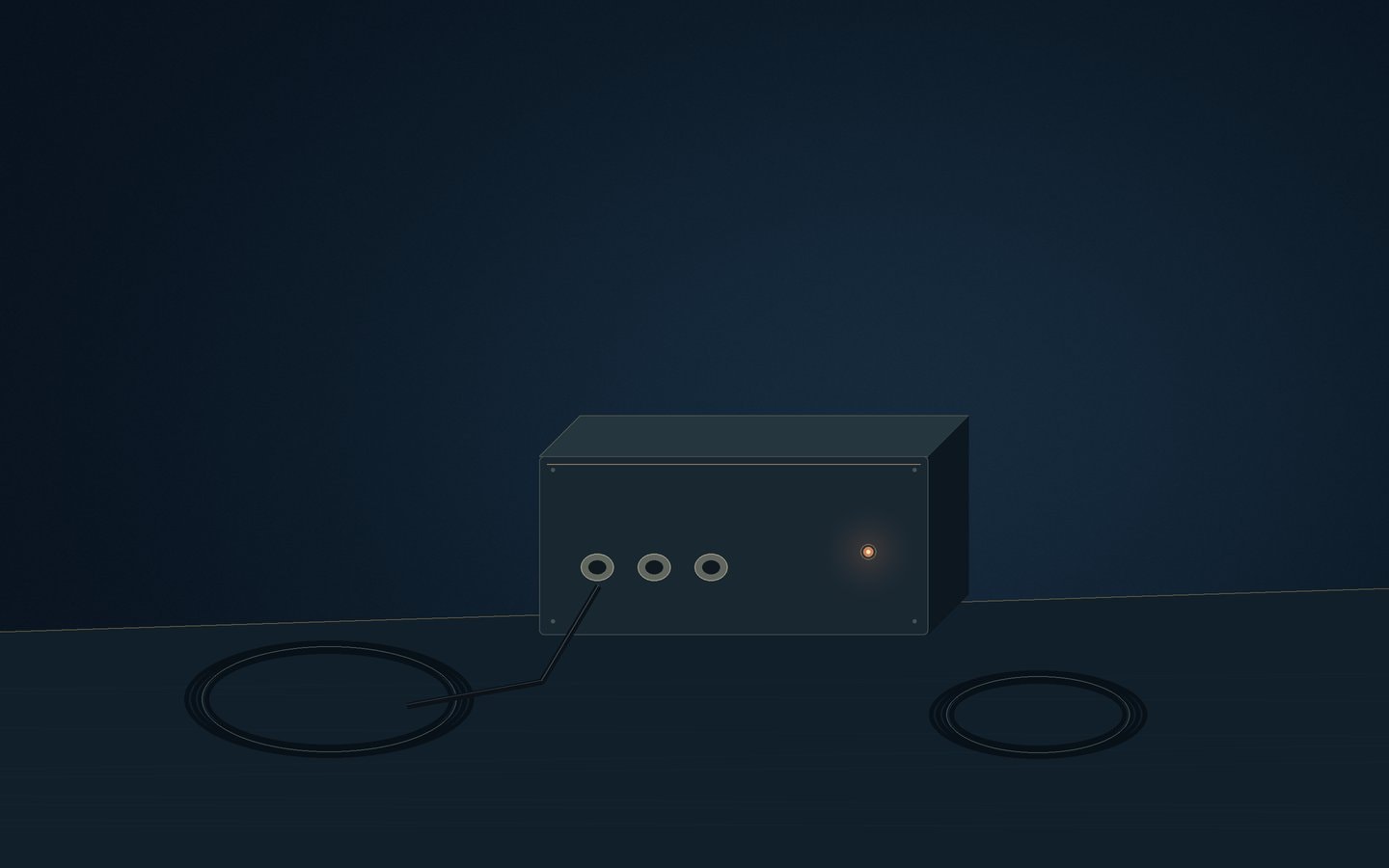 Dark rectangular enclosure beside coiled video leads and small indicator lights